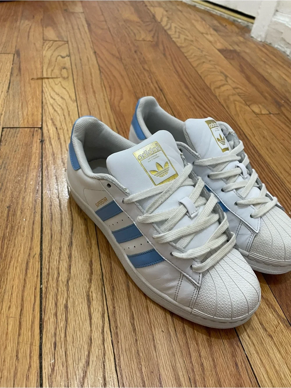 adidas Superstar Men’s Sneakers in White with Light Blue Stripes
